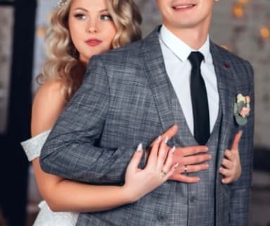 The bride embracing the groom from behind
