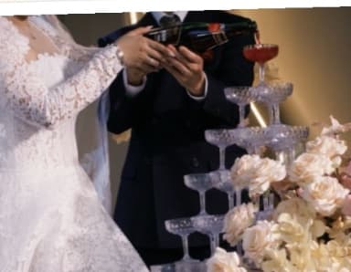 The couple pouring champagne over a glass tower